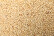 © New Africa - Granulated dried garlic as background, top view