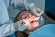 © Tatiana - Dentist performing a routine dental checkup using mirror and probe. Professional oral examination in a modern dental clinic focused on preventive care and oral health.