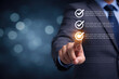 © Gambar Upi - Businessman selecting digital checklist items representing task completion approval workflow performance evaluation and business process management concept