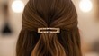 © photoplotnikov - Close-up of hair with stylish metal clip on young caucasian female featuring natural brown waves