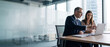 © Five Million Stock - Two professional business people working together. Partners mature man and woman discussing project in office. Team leader explain trainee working process using tablet pc computer. Banner, copy space