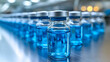 © VinakMotion - Rows of clear glass vials filled with vibrant blue liquid, set in a sterile laboratory environment with soft lighting