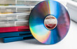 © Victoria - DVD discs in a plastic boxes with a disc in front of them on a white background top view.