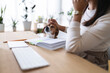 © Studio Marmellata - A person gently pets their dog while working at a desk with an open notebook and keyboard, creating a warm and productive atmosphere.