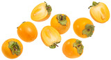 Falling kaki fruits isolated on white background, full depth of field