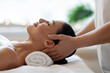 © Home-stock - Relaxing head massage techniques concept. Woman enjoying rejuvenating full body massage in spa salon, profile side view, closeup