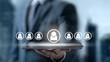 © Leo Lintang - Businessman holding a tablet with digital people icons, symbolizing HR management, recruitment, and talent selection in a modern corporate environment