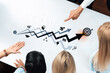 © InfiniteFlow - Overhead view of a diverse business team discussing growth strategies with graphical indicators and target goals in a modern workspace, showcasing collaboration and planning. Trope