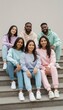 © kittipoj - Group of Friends Sitting on Steps in Coordinated Casual Outfits