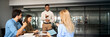 © insta_photos - Young happy African American male executive company leader discussing project management planning strategy working with diverse busy colleagues company team at office corporate board group meeting.