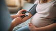 © Juliaap - Healthcare professional checking a pregnant woman's blood pressure with a stethoscope and cuff during a prenatal checkup, ensuring maternal and fetal health