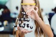 © Rawpixel.com - Young girl in a science lab holding a molecular model. The girl is focused on the molecular model. Science lab setting with a girl and a molecular model. Elementary school science education.