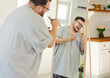 © Studio Romantic - Overweight happy man singing with comb as microphone in front of mirror at home. Chubby funny male person in glasses and pajamas enjoying song, karaoke performance of cheerful body positive singer
