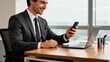 © Sebastian - Businessman using phone at desk