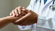 © Charlotte - Doctor holding patients hand