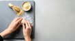 © Saliyem - Top view of hands kneading dough on a stone countertop next to a bowl of flour, food preparation background