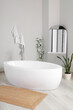 © Pixel-Shot - Interior of light room with bathtub, mirror and plants