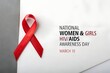 © UMAIR - A symbolic bright red awareness ribbon rests beside text commemorating national women and girls hiv aids awareness day on march tenth representing solidarity and support