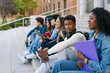 © Koldo_Studio - Group of diverse university students relaxing and studying together on campus, representing higher education success and learning