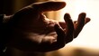 © alfa - A hand is cupped to receive or hold something gently in a warmly lit indoor setting from a close-up viewpoint
