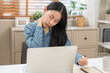 © KMPZZZ - Body muscles hurt stiff, face suffering asian young woman, girl neck pain, body ache while sitting work at home, holding massaging rubbing back, problem health care of office syndrome people concept.
