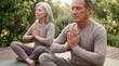 © Trendy Graphics - Meditating senior couple enjoying peaceful yoga together outdoors