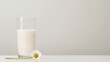© Helen-HD - A glass of milk sits on a table next to a single flower, creating a minimalist scene with a plain background