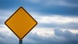 © MSTJAHANARA - A blank yellow diamond shaped road sign against a cloudy blue sky