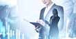© ImageFlow - Female business professional holding notebook, double exposure style, over light city background with data charts, concept of analysis and innovation