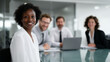 © Alexander - a group of business professionals having a meeting in a modern glass-walled conference room.