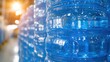 © Nurulstudio - Stacks of clear blue plastic bottles filled with glistening drinking water under dim light