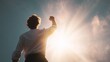 © VictorCanalesStudio - Man in victory pose expressing strength, power, and achievement under a bright sky with copy space