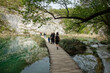 © Caio - Plitvicka Jezera, Croacia - 04.20.2025: tourists on platform in Plitvice Lakes National Park