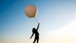 © MistoGraphy - Person holding a balloon in the air at sunset or sunrise with a beautiful sky background