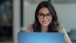 © LimeSky - Image of a self-assured young woman with glasses using a laptop in an office.png