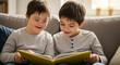 © BackgroundStudio - Two young boys reading a yellow book together sitting comfortabl