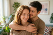 © raquel - Happy Couple Embracing at Home in Warm Natural Light