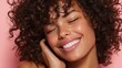 © LimeSky - Beauty concept featuring a joyful woman with curly hair radiant skin and bright teeth set against a pink backdrop