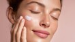 © LimeSky - Attractive young woman with eyes shut puts white cream on her face