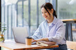 © David - Asian woman working on laptop at desk business concept.