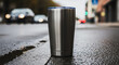 © CreativeIMGIdeas - Stainless Steel Insulated Tumbler on Wet City Street Pavement with Blurred Traffic Lights Background