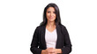 © Iván Moreno - Businesswoman standing smiling with hands clasped