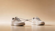 © Art_spiral - two beige sneakers tied together with knotted laces in minimalist studio scene symbolizing teamwork dependency relationship conflict and collaboration concept with copy space
