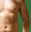 © schankz - A man with a green background. His chest is bare.