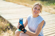 © luismolinero - Young blonde woman at outdoors doing sport with a bottle of water