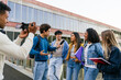 © Koldo_Studio - Journalism students filming and interviewing young adults about education and campus life for a news report
