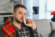 © Serhii - Sick man using nasal spray for cold symptoms