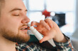 © Serhii - Man applying nasal spray for cold or allergy relief