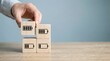 © Gambar - wooden blocks with battery icons and hand