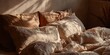 © horizon - Unmade bed with rumpled beige linen sheets and pillows, soft morning sunlight casting shadows across the texture in a cozy bedroom scene.